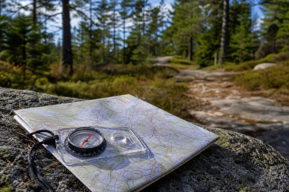 Orienteering compass and topographic map for land navigation