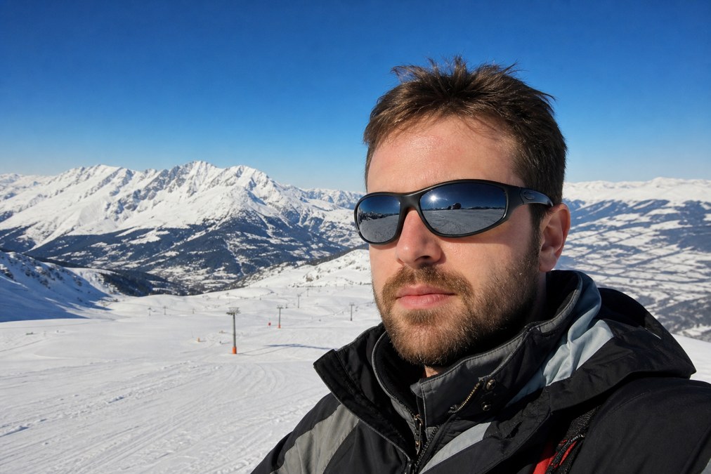 Skier wearing polarized sunglasses on a bright snowy slope