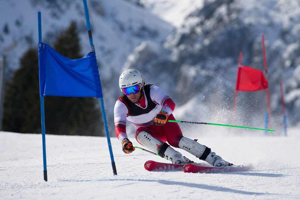 Alpine ski racer on a gated slalom course
