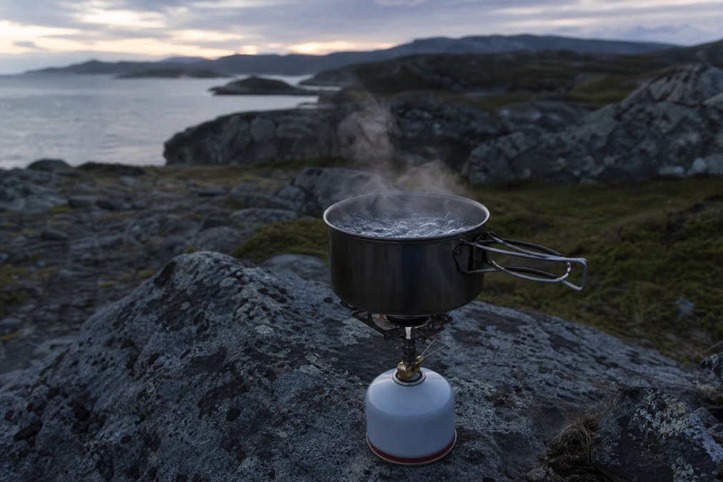 Pot of water at a rolling boil on a backpacking camp stove used as a no-gear water treatment fallback